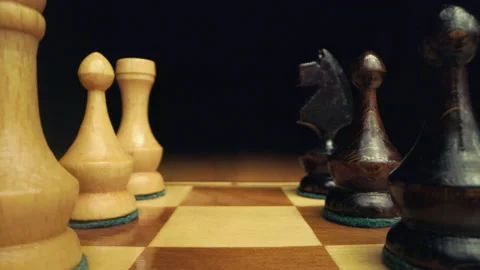Camera moving between two rows of chess pieces on a chessboard Stock Footage 149330098