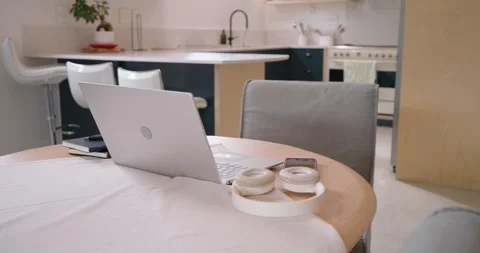 Camera is moving closer, revealing laptop and headphones on round table to show Stock Footage 341027150