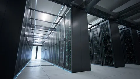 Camera moving in data center in dim light showing racks of server equipment. Stock Footage