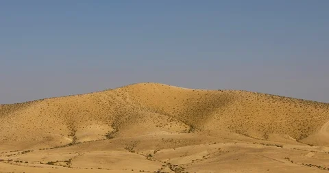 The camera moving down from top of the hill into desert Stock Footage 122340825