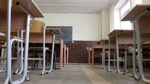 Camera moving on the floor in towards chalkboard in empty classroom Stock Footage 95523973