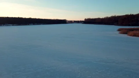 Camera moving forward above frozen lake Stock Footage 165998650