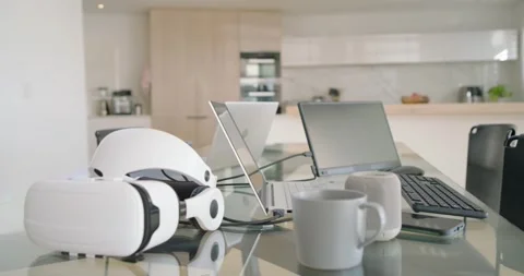 Camera is moving forward across glass dining table, drawing laptops, mugs and VR Stock Footage 335781015