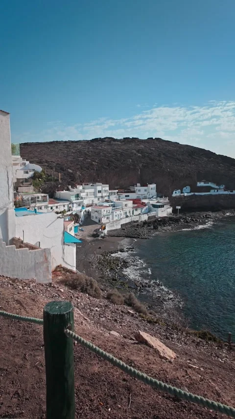 Camera moving forward revealing a coastal village on Gran Canaria Stock Footage 294278888
