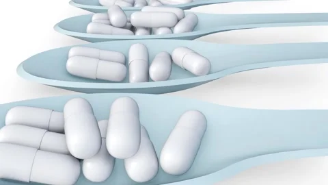 The camera is moving forward through an array of capsule-filled spoons Stock-Footage 334513444