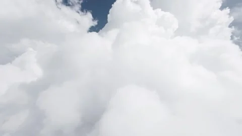 Camera moving forward through white clouds into blue sky Stock Footage 344419299
