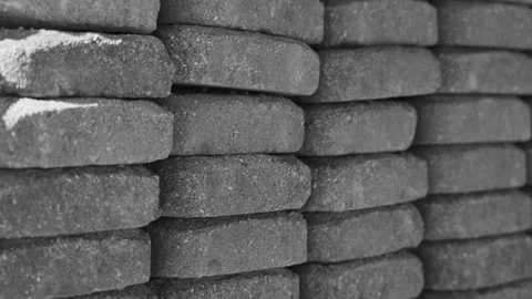 Camera moving laterally upward over the stacked bricks in black and white. Stock Footage 340923440