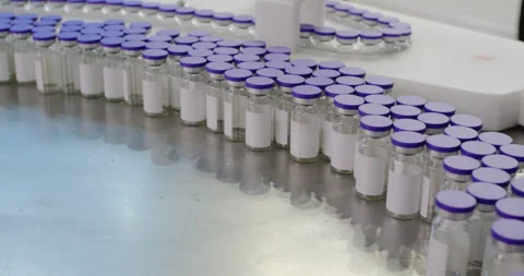 Camera moving over medical vials with purple caps Stock Footage 295220912