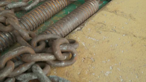 Camera moving over a pile of heavy rusty iron chains on the ground. Stock Footage 323717830