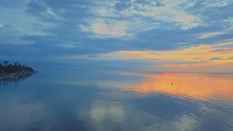 Camera moving up over sunet water of calm ocean Stock Footage 94151813