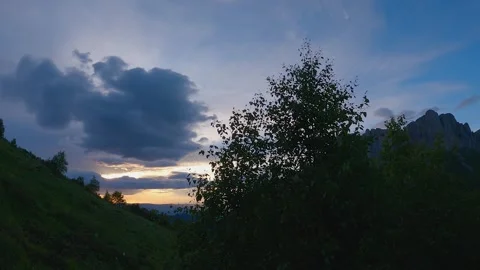 Camera moving parallel to mountainside. Hyperlapse. Beautiful view of sunset sky Stock Footage 247946318
