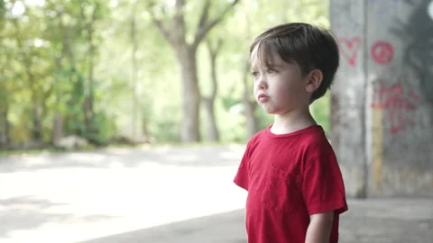 Camera moving right to left to take a shot of a young little boy in a red Stock Footage 161956569