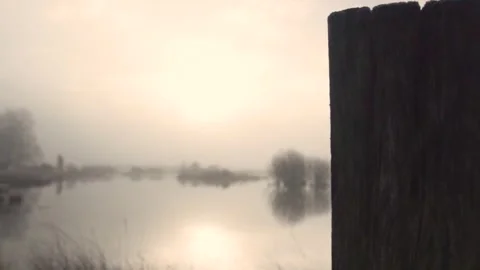 Camera moving right revealing misty lake at sunrise Video stock 293082797