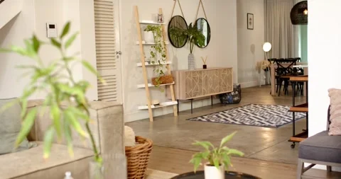 Camera is moving right, shifting focus from blurred plant to wooden console, Stock Footage 342233293
