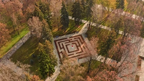 Camera moving right showing autumn city park maze Video stock 288252574