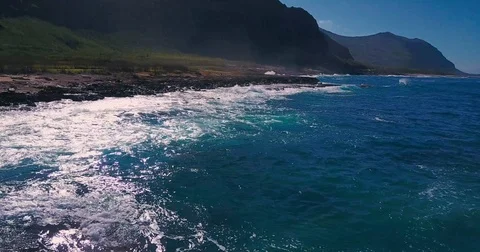 Camera moving from rocky coast into the ocean Stock Footage 79620927