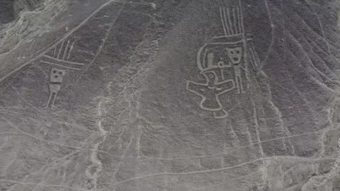 Camera moving sideways over small figures of the Nazca Lines geoglyphs made  Stock Footage 251932822