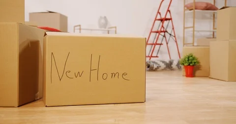 Camera moving in slow motion in front of the carton boxes and home stuff in the Video stock 100963013