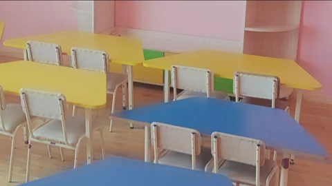 Camera moving smoothly across empty preschool classroom showing colorful small 스톡 동영상 348288676