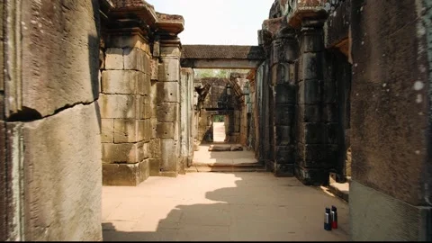 Camera moving through the ancient stone corridor. Majestic khmer architecture in Stock Footage 323077424
