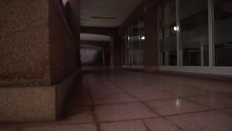 Camera moving through dark empty corridor at night Video stock 293158299