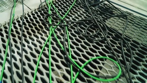 Camera moving through green, black and red  cables. On the metallic roof.  Stock Footage 199221442