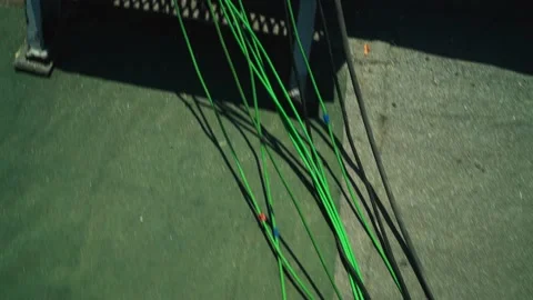 Camera moving through green, black and red  cables. On the metallic roof.  Video stock 199221518