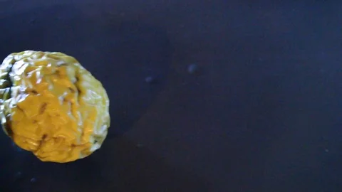 Camera moving through scene for two yellow passion fruits and dramatic light Stock Footage 115372312