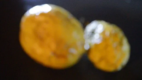 Camera moving through scene for two yellow passion fruits and dramatic light Stock Footage 115373335