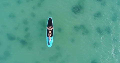 Camera moving to the top and around Attractive woman in bikini is sunbathing on Video stock 84774031