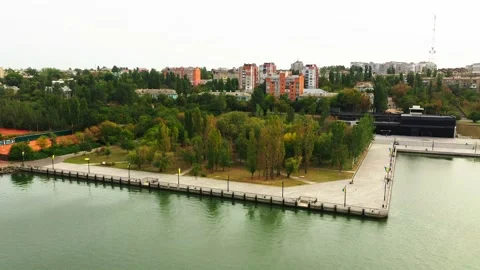 Camera moving towards the beautiful pier near the city. Trees, parks, buildings Stock-Footage 144730577