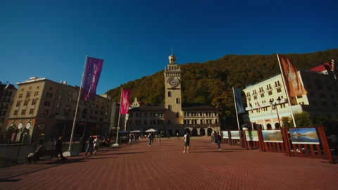 Camera is moving towards the clock tower and hotels. tourists are walking around Stock Footage 204049137