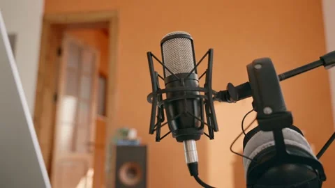 Camera moving towards professional microphone in home recording studio setup Stock Footage 218476432