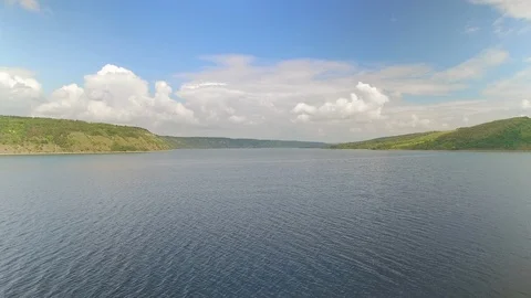 Camera moving upwards over nice beautiful river and hills landscape Stock Footage 99338904