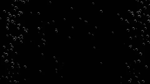 The camera observes a smooth, slow rise of air bubbles against a black Stockbeeldmateriaal 151813472