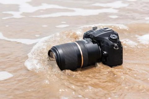 Camera in Ocean Waves Stock Photos