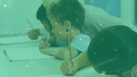 Camera opening students writing widening revealing teacher guiding boy's writing Stock Footage 313329990