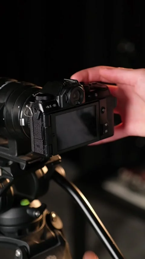 Camera operator adjusting settings on digital screen Stock Footage 306779839