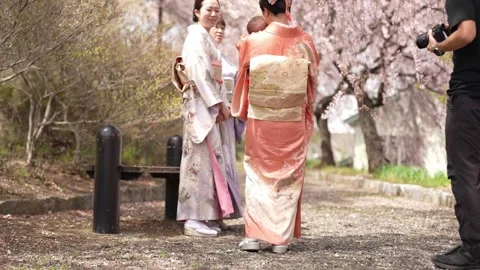 Camera Operator Beside Kimono Group with Baby Stockbeeldmateriaal 344855675