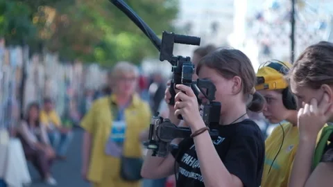 Camera operator with crew filming interview Stock Footage 205196928
