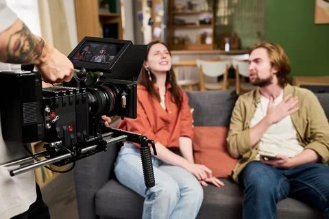 Camera Operator Filming Man and Woman for Video Content Stock Photos