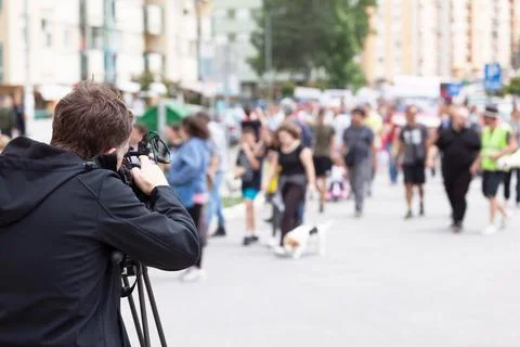 Camera operator filming protesters during street protest Stock Photos