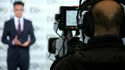 Camera Operator On News Room Shoot Media Movie. Cameraman Working Stock Footage 147994556