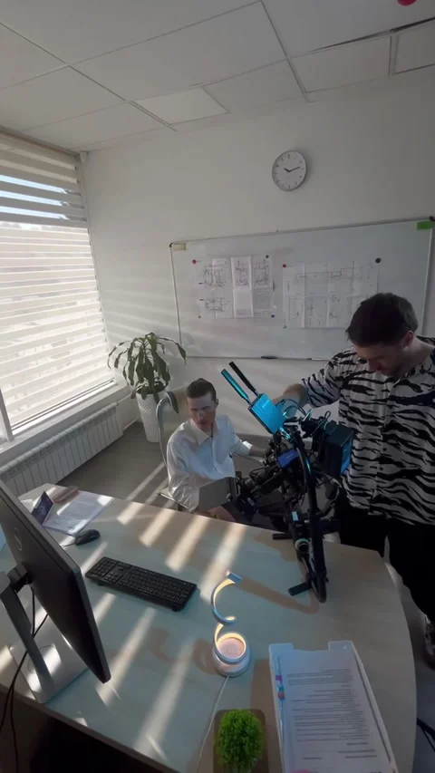 Camera operator places steadicam beside actor in chair Stock Footage 313866452