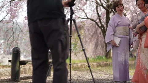 Camera operator prepares a spring kimono portrait 스톡 동영상 343697624