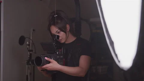 Camera Operator Recording Video with a Camera on a Stabilizer Video stock 208766356