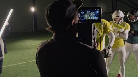 Camera Operator Shooting Portrait of Gridiron Football Team on Pitch Stock Footage 335390199