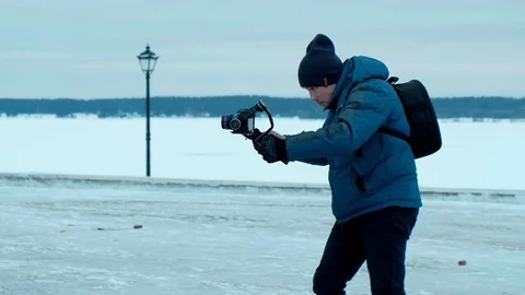 Camera operator Walk with electronic stabilizer in winter Video stock 84632261