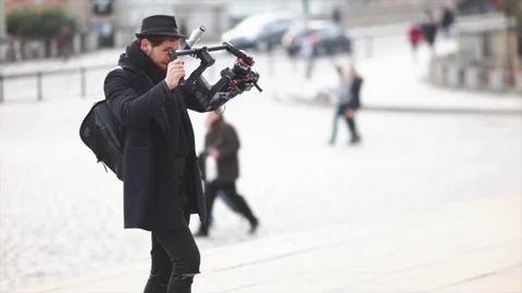 Camera Operator Walking With Electronic Stabilizer Stock Footage 73024611
