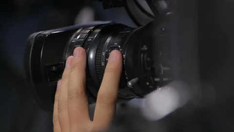 Camera operator working with a cinema broadcast TV camera. Back view Stock Footage 94373294